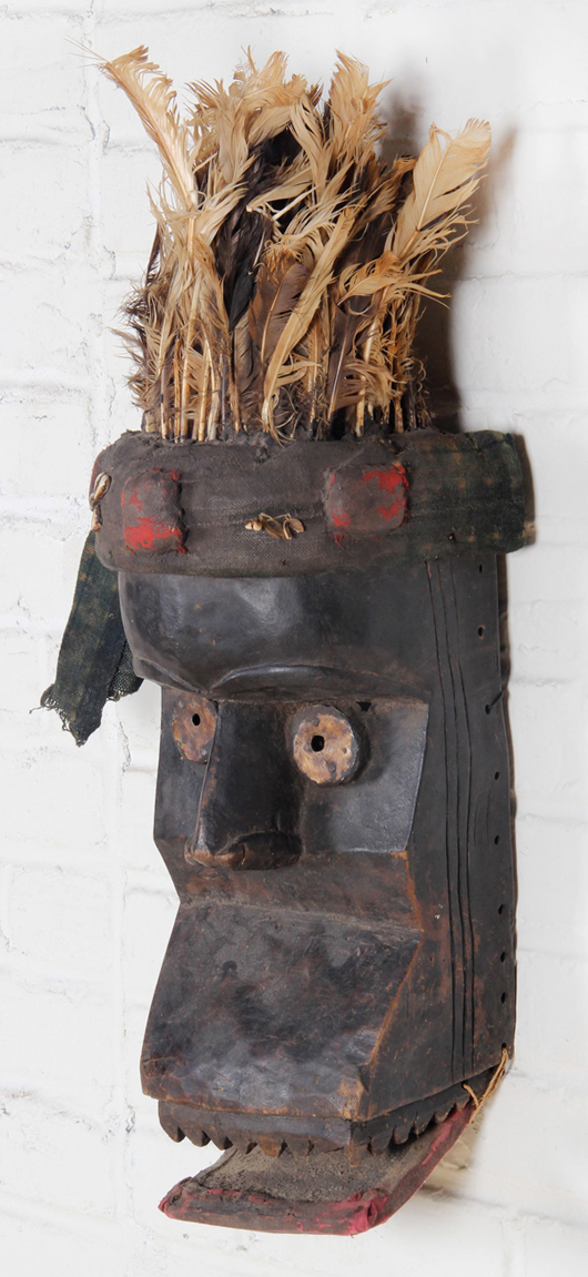 Vintage African carved wood mask with headdress and movable mouth, 26 x 8 x 8.5 inches. Estimate: $100-$150. Material Culture image.