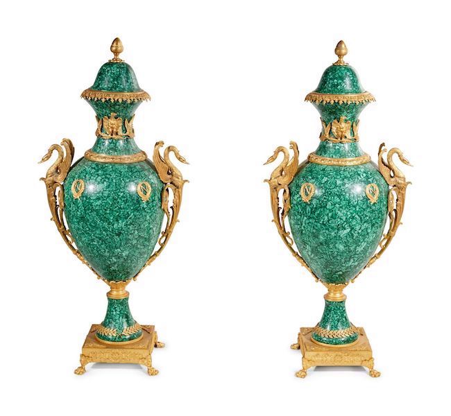 Pair of 20th-century Empire-style gilt-bronze mounted urns veneered in malachite, which earned $10,000 plus the buyer’s premium in April 2021. Image courtesy of Hindman and LiveAuctioneers.